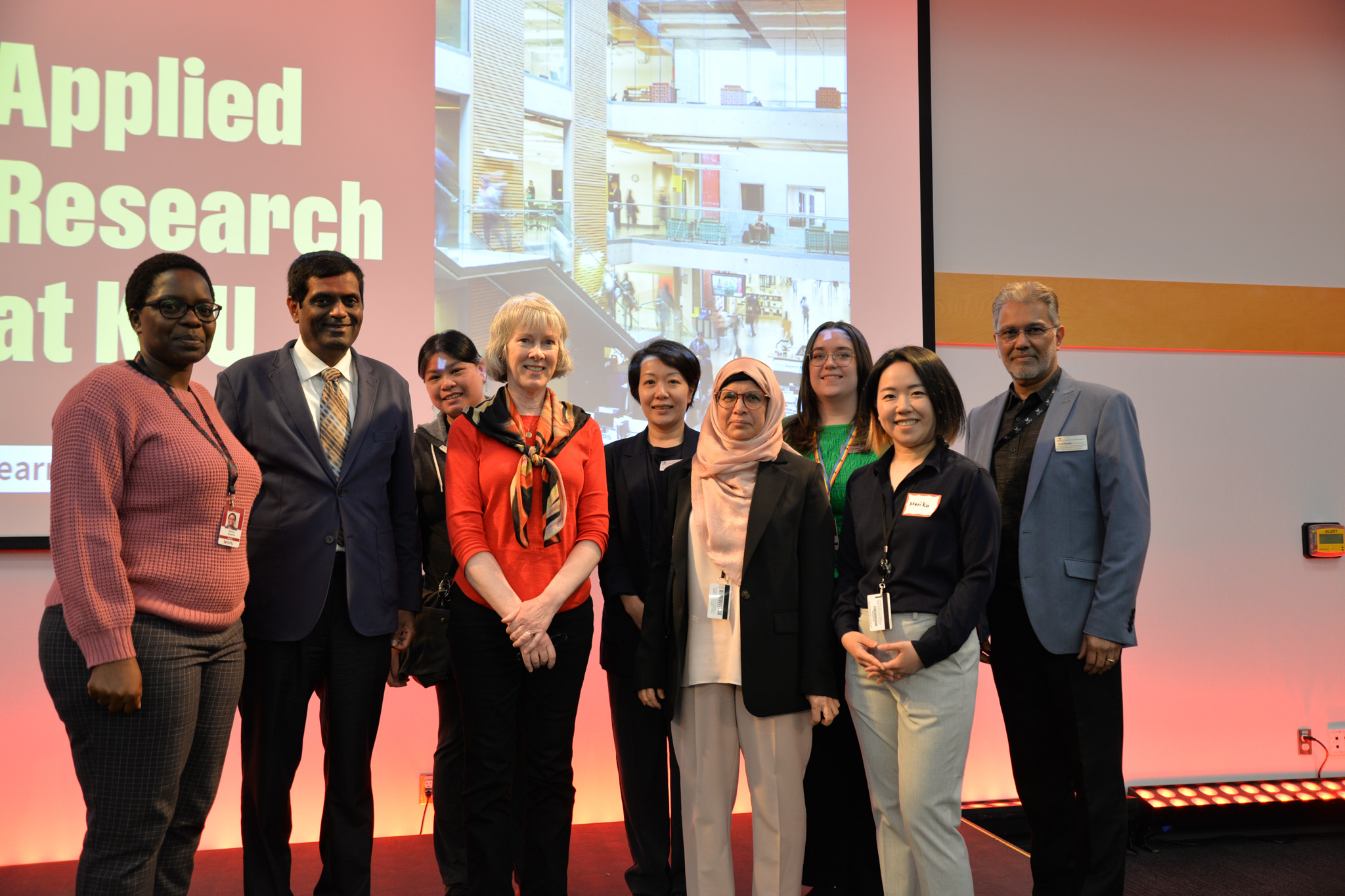 Group photo of the research office staff on stage
